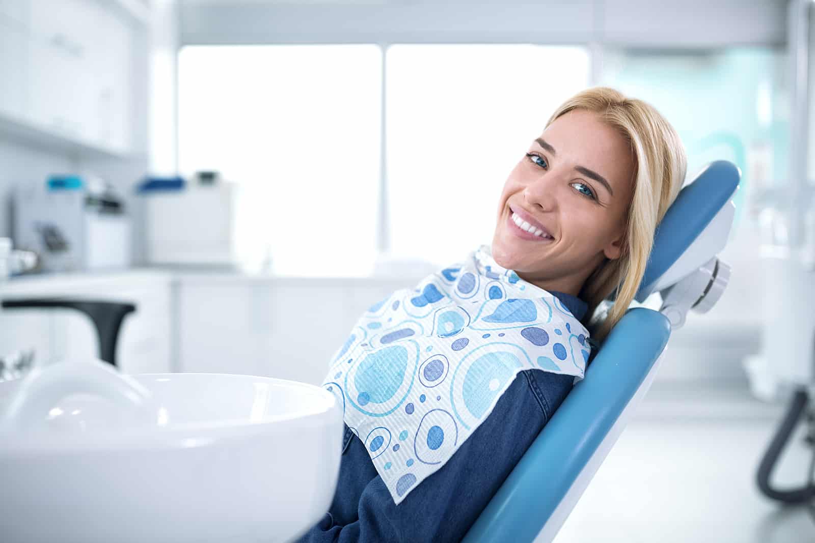 woman.smiling.dental chair